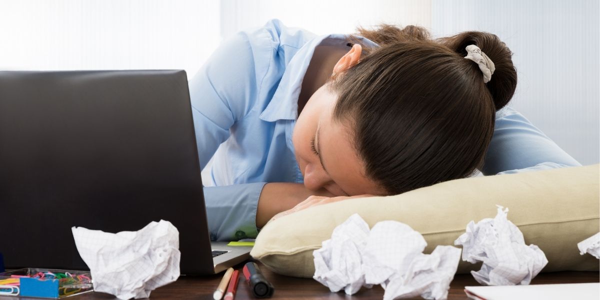 woman sleeping at desk due to lack of sleep