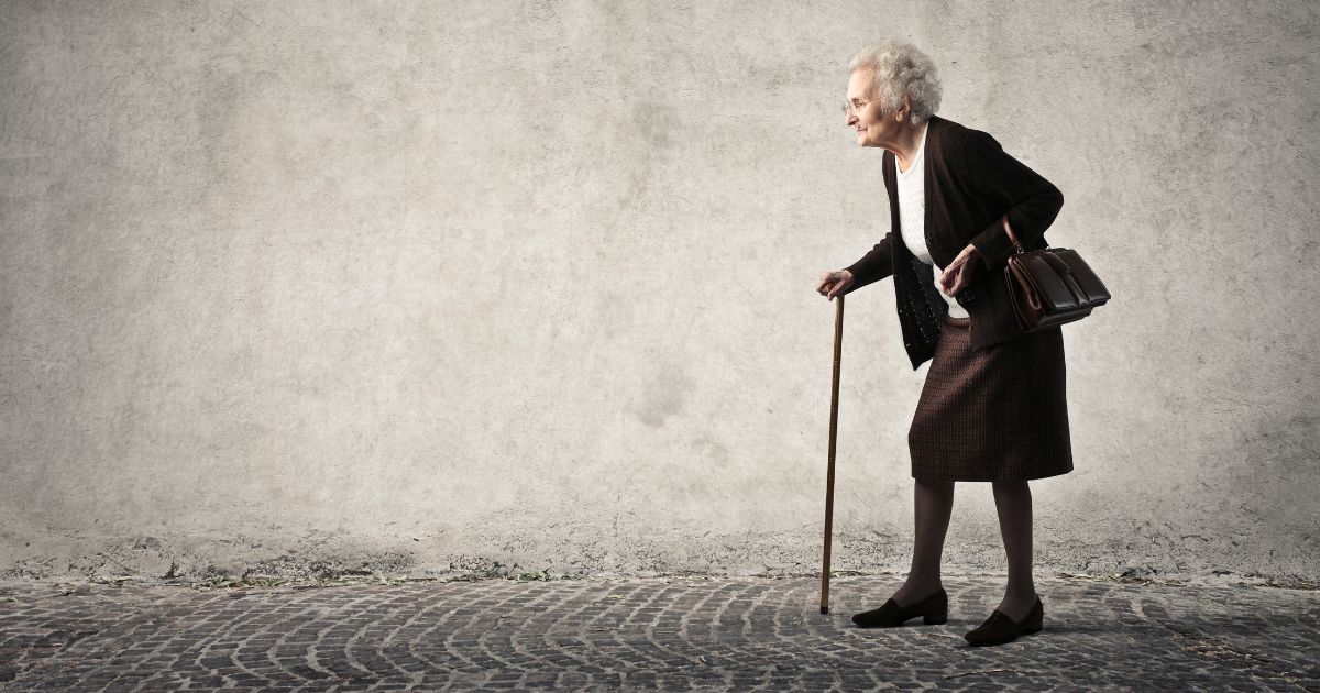lady with walking stick suffering from joint pain